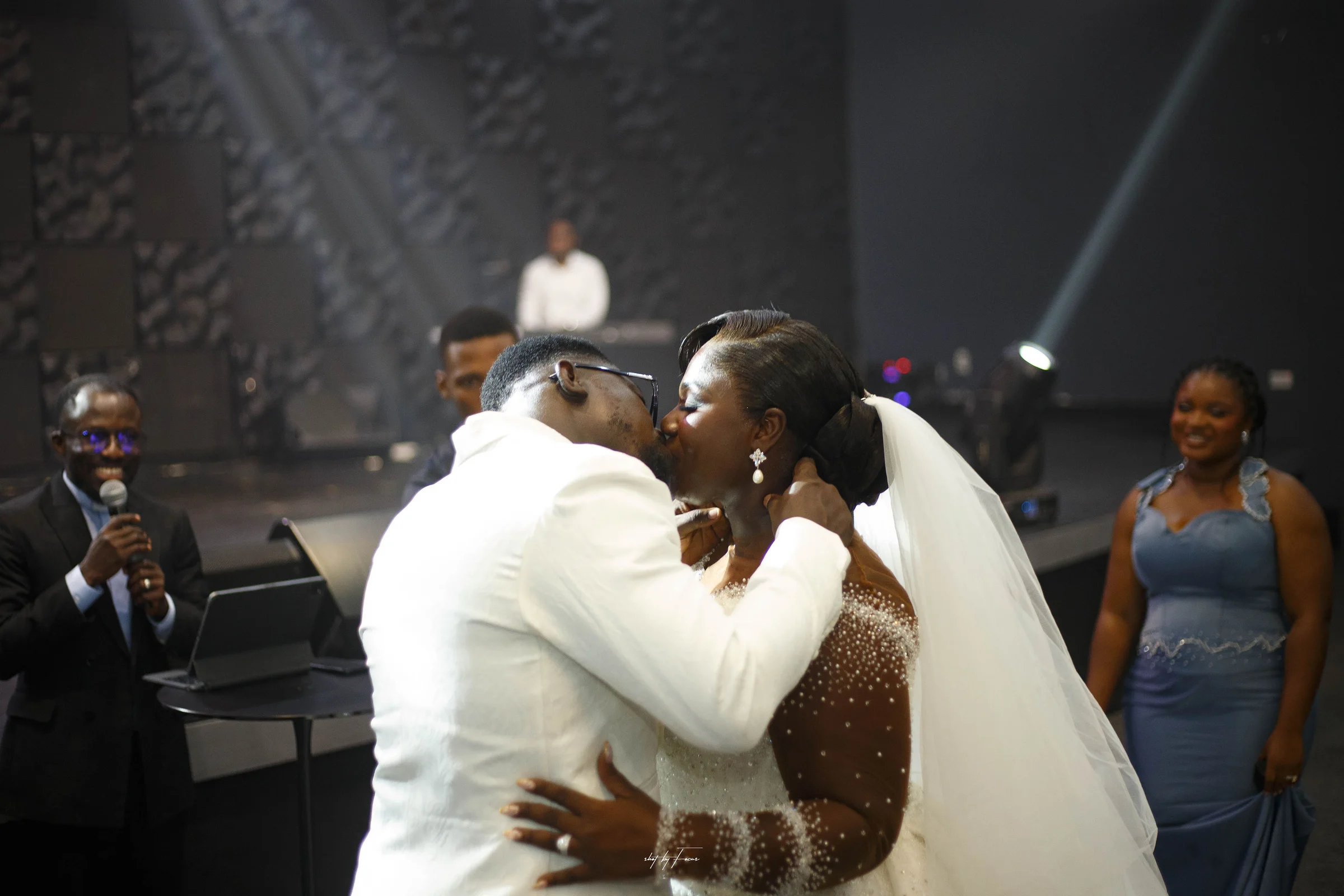 Godson and Priscilla sharing a kiss on their wedding day